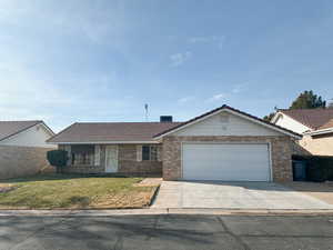 Ranch-style home with a garage and a front lawn