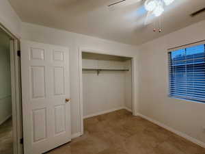 Unfurnished bedroom featuring a textured ceiling, a closet, and ceiling fan