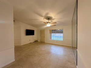 Interior space featuring ceiling fan and vaulted ceiling