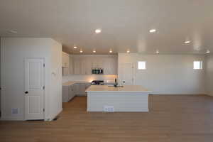 Upgraded cabinets, coutnertops, appliances,  and flooring in the open concept floorplan