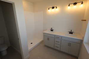 Owner's suite bath with upgraded tile flooring and a step in shower
