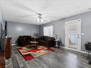 Living room featuring dark hardwood / wood-style floors and ceiling fan