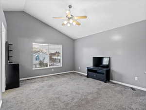 Unfurnished living room with light colored carpet, ceiling fan, and lofted ceiling