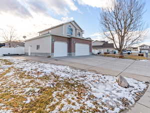 Snow covered property featuring a garage