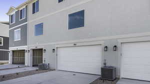 Exterior space featuring central AC unit and a garage