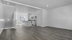 Unfurnished living room featuring light wood-type flooring and sink