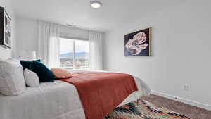 Bedroom featuring carpet flooring and a mountain view