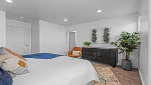 Carpeted bedroom featuring a textured ceiling