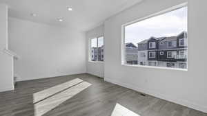 Empty room featuring wood-type flooring