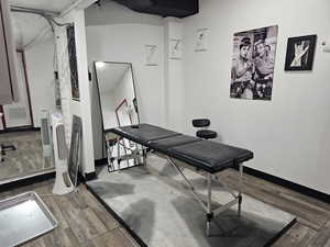 Workout area featuring hardwood / wood-style floors