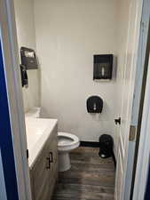 Bathroom featuring vanity, hardwood / wood-style flooring, and toilet