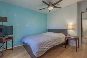 Bedroom featuring light hardwood / wood-style flooring and ceiling fan