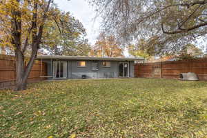 Rear view of house featuring a lawn