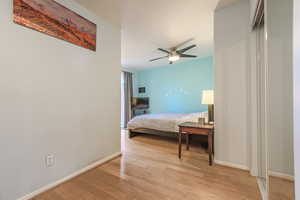 Bedroom with ceiling fan and light wood-type flooring