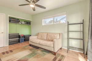 Living room featuring ceiling fan and light wood-type flooring