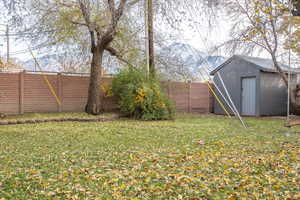 View of yard featuring a mountain view and a shed