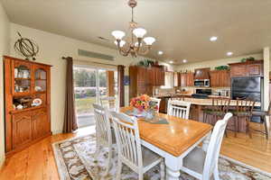 Dining area featuring an inviting chandelier and light hardwood / wood-style flooring