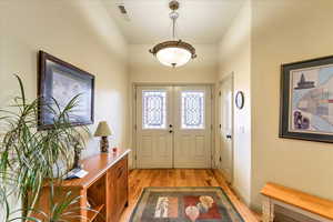 Entryway featuring french doors and light wood-type flooring