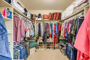 Walk in closet featuring carpet flooring