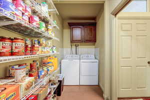 Laundry room featuring cabinets and separate washer and dryer