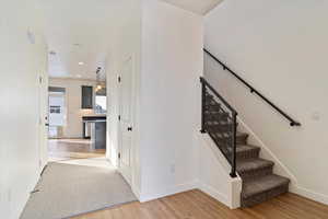 Stairs with hardwood / wood-style floors