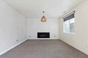 Unfurnished living room with carpet floors