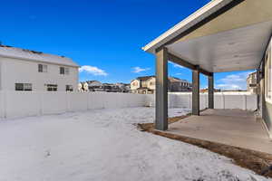 Snowy yard with a patio