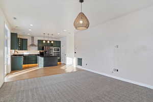 Unfurnished living room featuring light hardwood / wood-style floors and sink