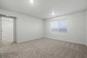 Carpeted empty room with a textured ceiling