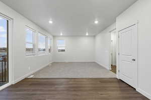 Spare room with dark wood-type flooring