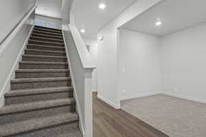 Stairway featuring wood-type flooring