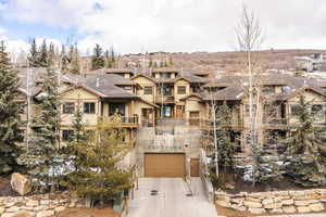 View of front of property with a balcony and a garage