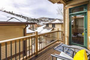 Snow covered deck featuring a mountain view