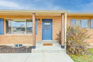 Doorway to property featuring a porch