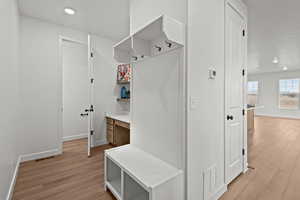 Mudroom with light hardwood / wood-style floors