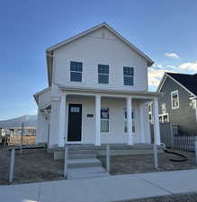 View of front of home with a mountain view and covered porch