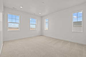 Empty room with light colored carpet