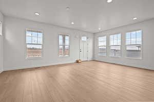 Unfurnished living room with light hardwood / wood-style floors