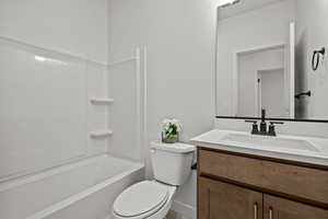 Full bathroom featuring vanity, toilet, and bathing tub / shower combination