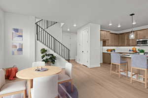 Dining space with light wood-type flooring