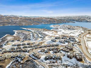 Snowy aerial view with a water and mountain view