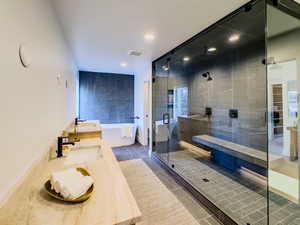 Bathroom featuring shower with separate bathtub, tile patterned floors, ceiling fan, and sink