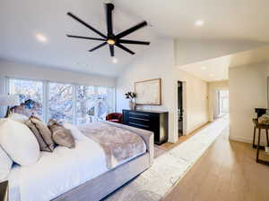 Bedroom with ceiling fan, high vaulted ceiling, and light hardwood / wood-style floors