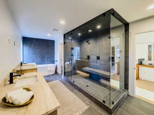 Bathroom with tile patterned floors, vanity, and independent shower and bath