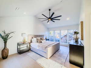 Bedroom featuring vaulted ceiling, light hardwood / wood-style flooring, and ceiling fan