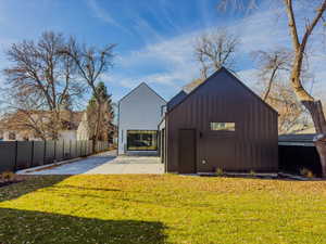 View of outbuilding featuring a lawn