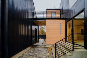 View of side of home featuring a balcony