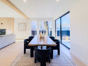 Dining room with beamed ceiling and light hardwood / wood-style floors