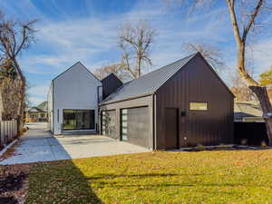 View of outbuilding featuring a lawn