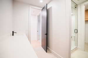 Bathroom featuring vanity and a shower with shower door